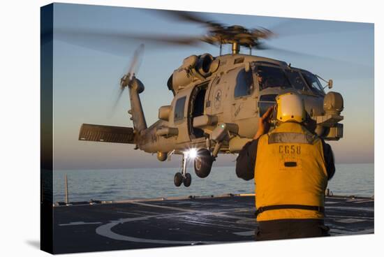 Boatswain's Mate Guides an Mh-60R Sea Hawk onto the Flight Deck-null-Stretched Canvas