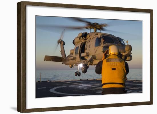 Boatswain's Mate Guides an Mh-60R Sea Hawk onto the Flight Deck-null-Framed Photographic Print