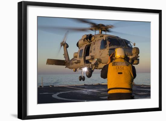 Boatswain's Mate Guides an Mh-60R Sea Hawk onto the Flight Deck-null-Framed Photographic Print