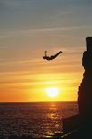Cliff Diver above Setting Sun-Bob Krist-Photographic Print