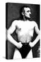 Bodybuilder with Thumbs Tucked in Belt-null-Stretched Canvas