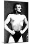Bodybuilder with Thumbs Tucked in Belt-null-Mounted Art Print