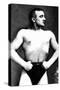 Bodybuilder with Thumbs Tucked in Belt-null-Stretched Canvas