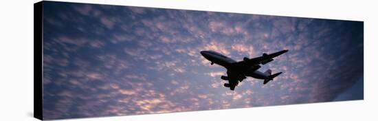 Boeing 747 Airplane in Flight Against Evening Clouds-null-Stretched Canvas