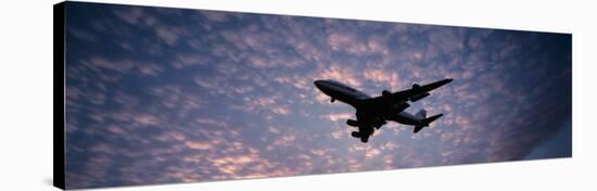 Boeing 747 Airplane in Flight Against Evening Clouds-null-Stretched Canvas