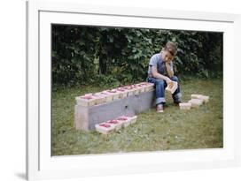 Bored Child Sitting with Raspberry Cartons-William P. Gottlieb-Framed Photographic Print