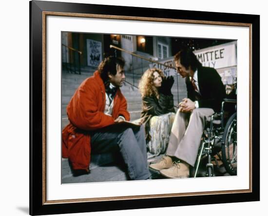 BORN ON THE FOURTH OF JULY, 1989 directed by OLIVER STONE On the set, Oliver Stone directs Kira Sed-null-Framed Photo