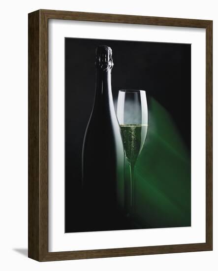 Bottle and Glass of Sparkling Wine in Green Light-null-Framed Photographic Print