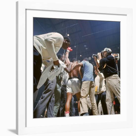 Boxer Cassius Clay, aka Muhammad Ali, Raising Fist in Triumph After Beating Sonny Liston-John Dominis-Framed Premium Photographic Print