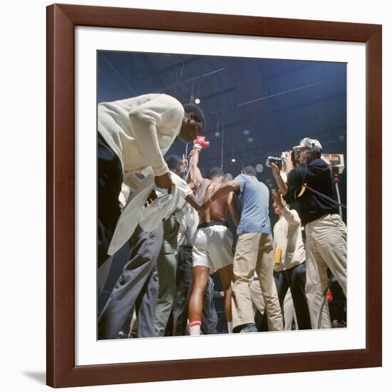 Boxer Cassius Clay, aka Muhammad Ali, Raising Fist in Triumph After Beating Sonny Liston-John Dominis-Framed Premium Photographic Print