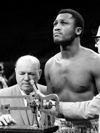 https://imgc.allpostersimages.com/img/posters/boxer-joe-frazier-at-the-weigh-in-for-his-fight-against-muhammad-ali_u-L-P47T6F0.jpg?artPerspective=n