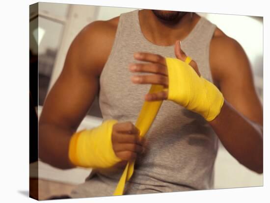 Boxer Wrapping His Hands-Chris Trotman-Stretched Canvas