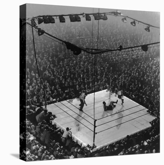 Boxing Ring as Heavyweight Champion Joe Louis Lies on Canvas, after Floored by Jersey Joe Walcott-Gjon Mili-Stretched Canvas