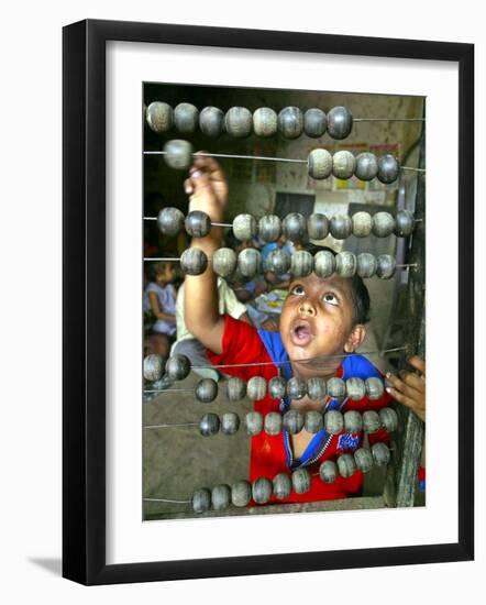 Boy, 3, Counts on an Abacus at a School in Allahabad-null-Framed Photographic Print