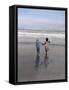 Boy and Girl on at Edge of Ocean Running and Holding Hands.-Nora Hernandez-Framed Stretched Canvas