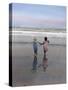 Boy and Girl on at Edge of Ocean Running and Holding Hands.-Nora Hernandez-Stretched Canvas