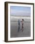 Boy and Girl on at Edge of Ocean Running and Holding Hands.-Nora Hernandez-Framed Giclee Print