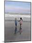 Boy and Girl on at Edge of Ocean Running and Holding Hands.-Nora Hernandez-Mounted Giclee Print