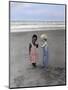 Boy and Girl on Beach Listening to Sea Shell-Nora Hernandez-Mounted Giclee Print