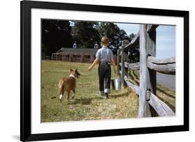 Boy and His Dog Walking Along a Fence-William P. Gottlieb-Framed Photographic Print