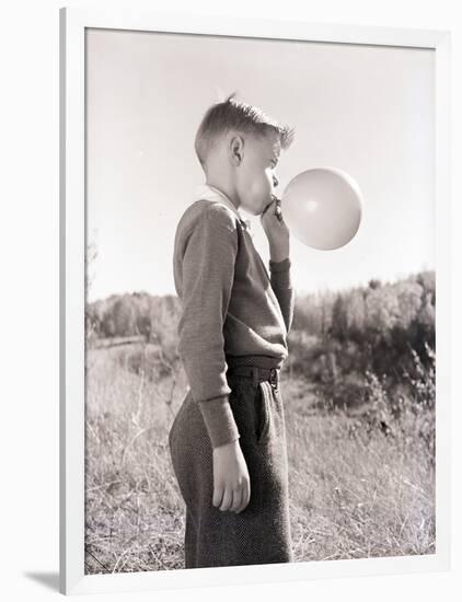 Boy Blowing a Balloon-Philip Gendreau-Framed Photographic Print