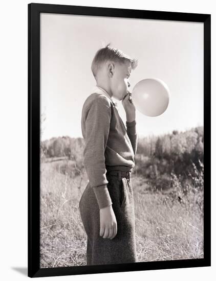 Boy Blowing a Balloon-Philip Gendreau-Framed Photographic Print