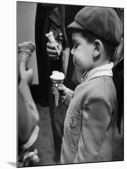 Boy Eating Ice Cream Cone at the Circus in Madison Square Garden-Cornell Capa-Mounted Photographic Print