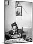 Boy Eating Spaghetti under Picture of His Brother Who Died During Invasion of Sicily-null-Mounted Photographic Print