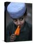 Boy Eats an Ice Lolly in a Neighborhood on the Outskirts of Islamabad, Pakistan-null-Stretched Canvas