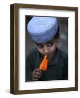 Boy Eats an Ice Lolly in a Neighborhood on the Outskirts of Islamabad, Pakistan-null-Framed Photographic Print