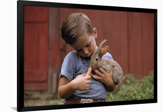 Boy Feeding a Rabbit-William P. Gottlieb-Framed Photographic Print