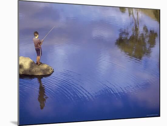 Boy Fishing from a Rock on a Pond-null-Mounted Photographic Print