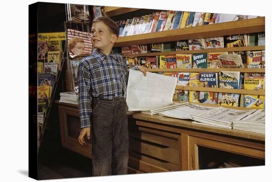 Boy Holding Paper in Newsstand-William P. Gottlieb-Stretched Canvas