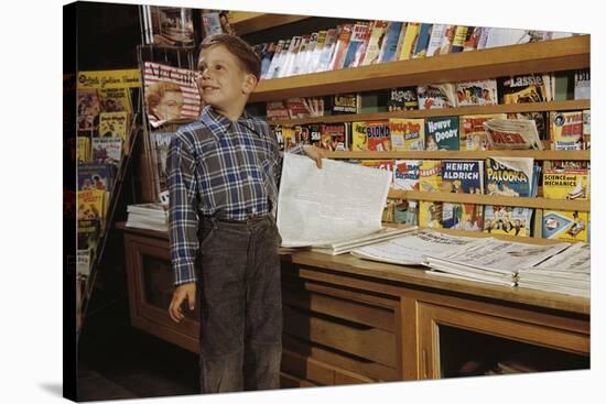 Boy Holding Paper in Newsstand-William P. Gottlieb-Stretched Canvas