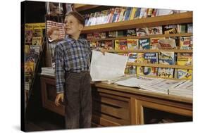 Boy Holding Paper in Newsstand-William P. Gottlieb-Stretched Canvas