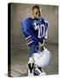 Boy in an Oversized Football Uniform Holding a Helmet-null-Stretched Canvas