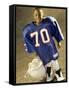 Boy in an Oversized Football Uniform Holding a Helmet-null-Framed Stretched Canvas