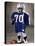 Boy in an Oversized Football Uniform Wearing a Helmet-null-Stretched Canvas