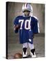 Boy in an Oversized Football Uniform Wearing a Helmet-null-Stretched Canvas