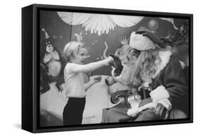 Boy Kissing African American Santa Claus in Unidentified Department Store. 1970-Ralph Morse-Framed Stretched Canvas