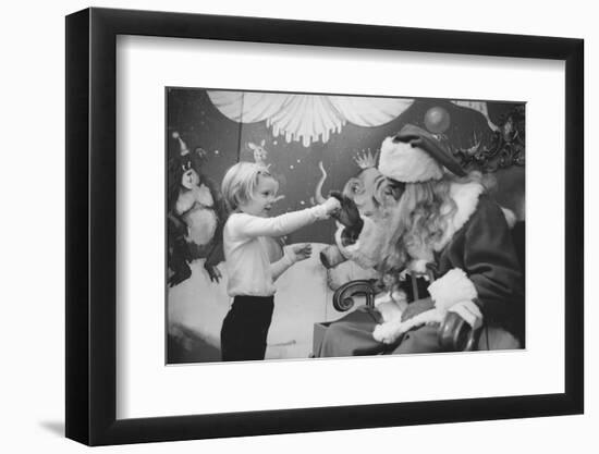 Boy Kissing African American Santa Claus in Unidentified Department Store. 1970-Ralph Morse-Framed Photographic Print