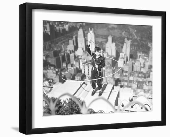 Boy on Ledge Twirling a Lasso-null-Framed Photographic Print