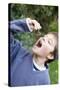 Boy Pretending To Eat An Earthworm-Ian Boddy-Stretched Canvas