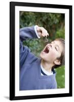 Boy Pretending To Eat An Earthworm-Ian Boddy-Framed Photographic Print