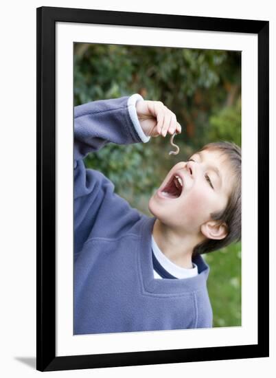 Boy Pretending To Eat An Earthworm-Ian Boddy-Framed Photographic Print