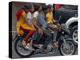 Boy Rides a Motorbike with Four Girls, as it Drizzles in Hyderabad, India-null-Stretched Canvas