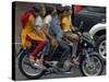 Boy Rides a Motorbike with Four Girls, as it Drizzles in Hyderabad, India-null-Stretched Canvas