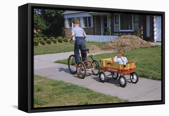 Boy Riding Tricycle and Towing Wagon-William P. Gottlieb-Framed Stretched Canvas