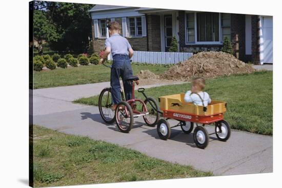 Boy Riding Tricycle and Towing Wagon-William P. Gottlieb-Stretched Canvas