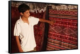 Boy showing a rug in a carpet shop, Toujane, Tunisia-Godong-Framed Stretched Canvas